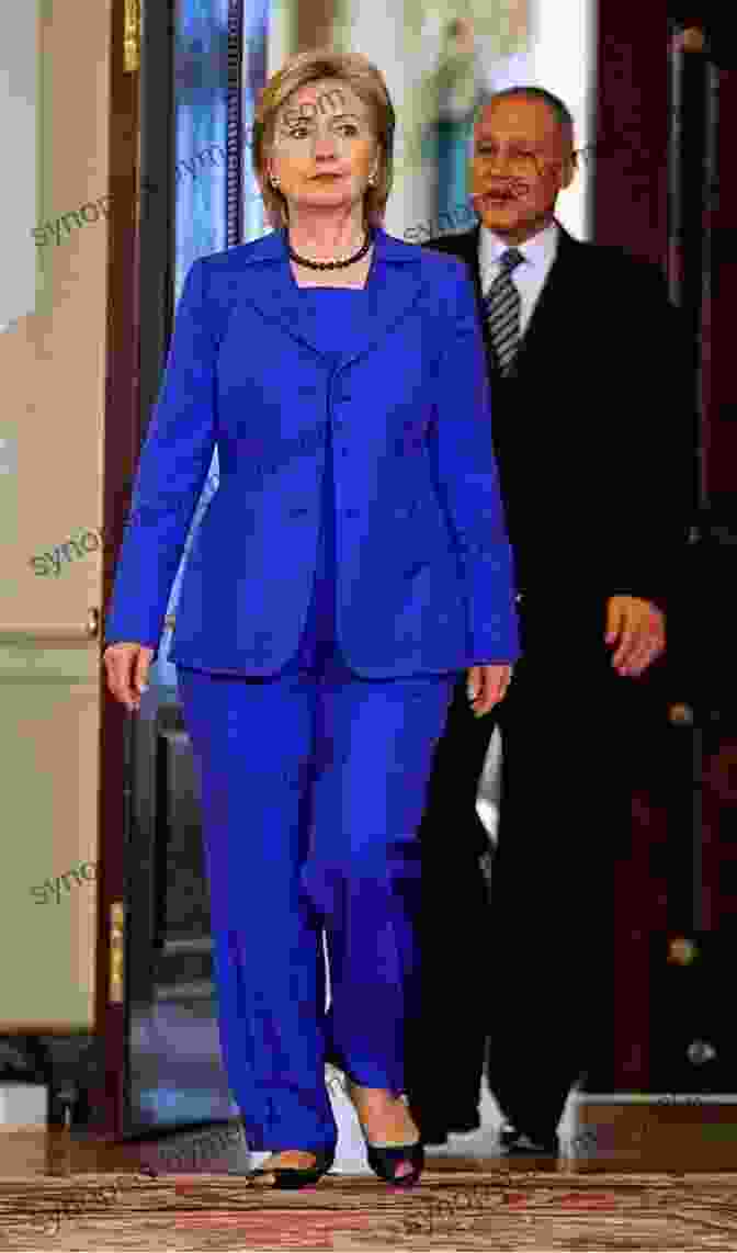 Hillary Clinton Wearing A Blue Suit And A Pearl Necklace, Smiling First Women: The Grace And Power Of America S Modern First Ladies